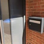 sole external post box mounted next to a modern front door