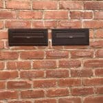 SM Copper Through The Wall External Post Box installed in a brick wall