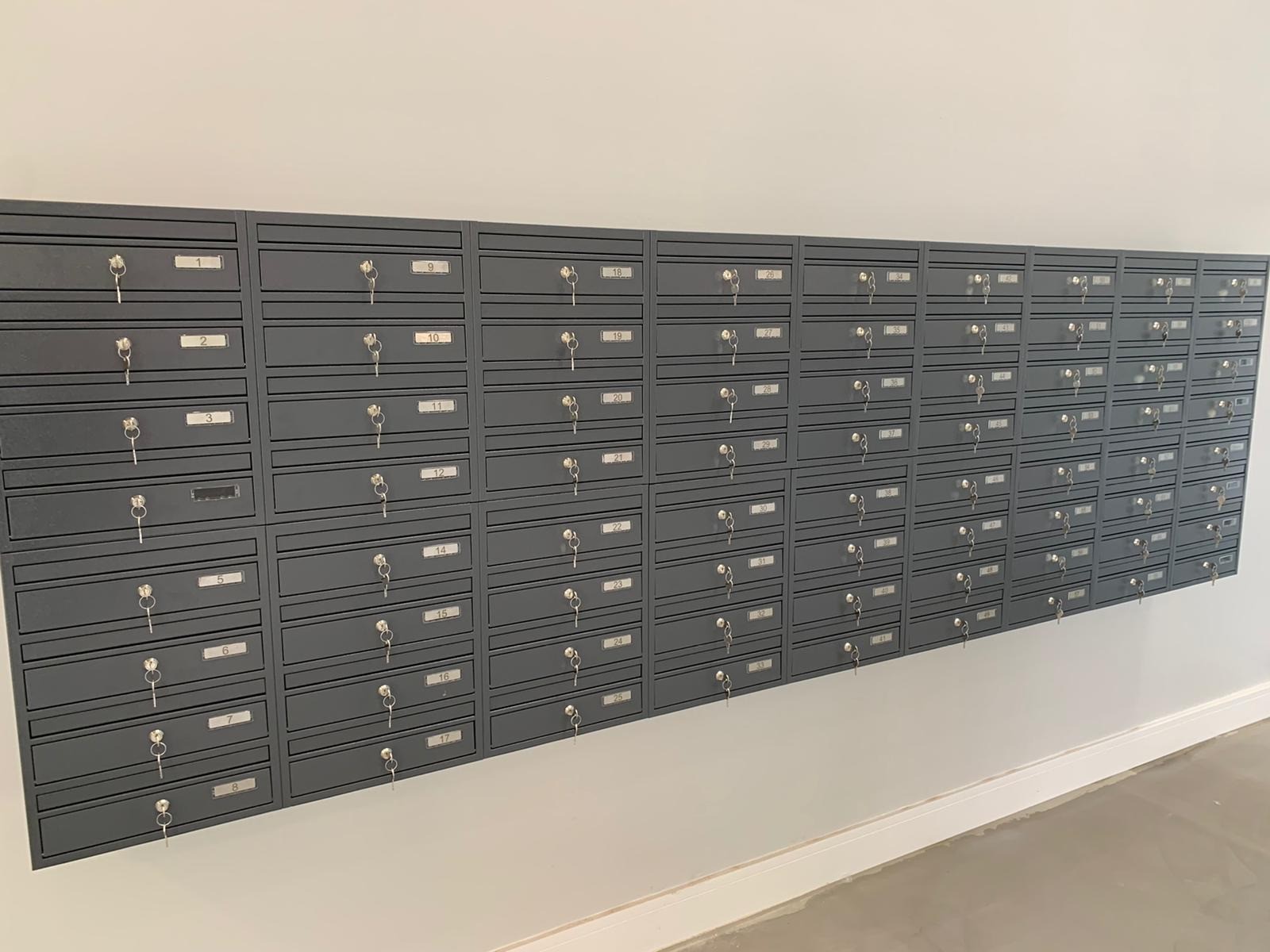 communal post boxes on the wall in dark grey colour