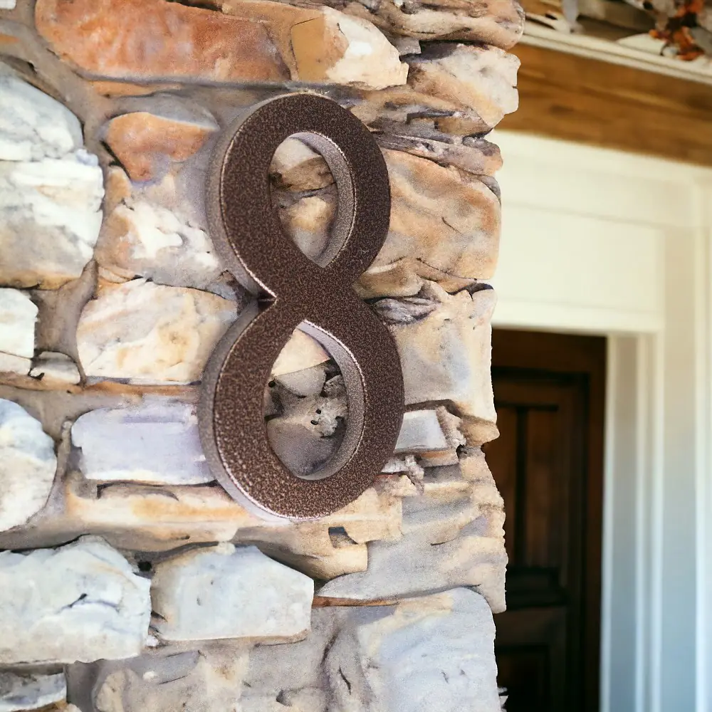 Large street numbers for house, 190 mm bronze finish mounted on stone wall